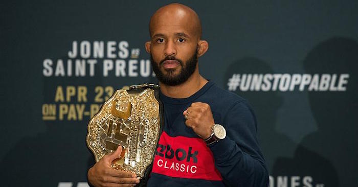 Demetrious Johnson with his UFC flyweight title over his shoulder.