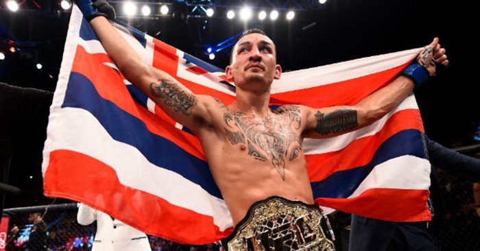UFC champ Max Holloway with the Hawaiian flag and UFC belt