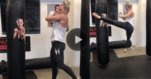 Former UFC bantamweightr champion Holly Holm is beating up a heavy bag with a picture of featherweight champion Cris Cyborg on it.